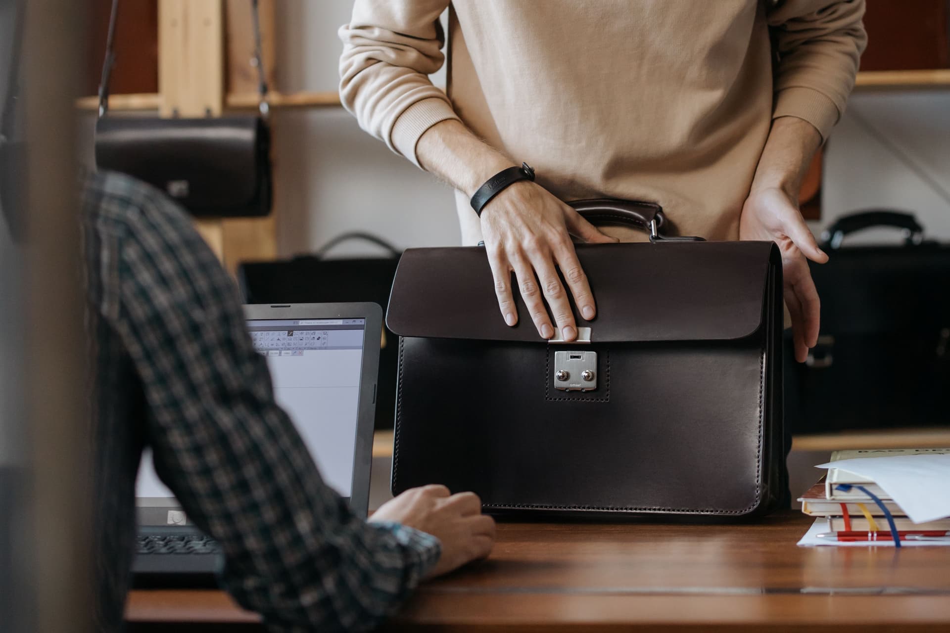 A leather briefcase on a wooden desk